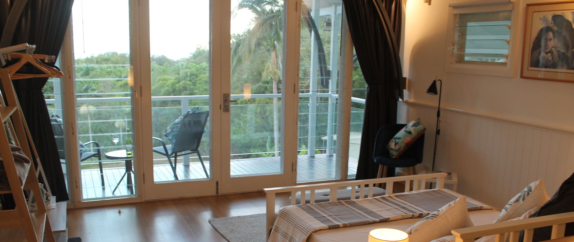 Queen studio bed looking out to ocean Inside view over queen size bed looking out to private balcony and ocean views